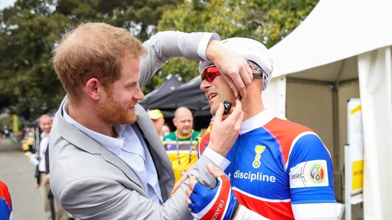 Exclusive behind the scenes of Prince Harry, Duke of Sussex helping put on helmet at the Invictus Games in Sydney