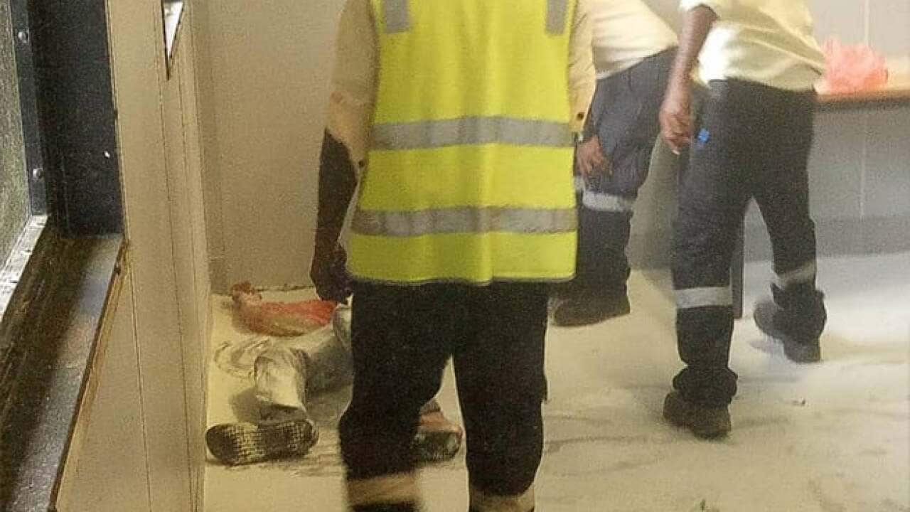 A Somali refugee is tended to by authorities.