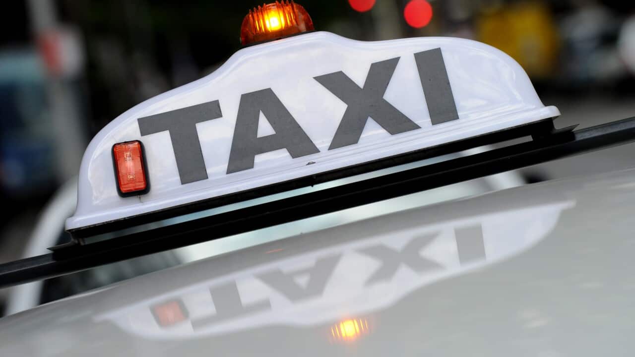 A taxi seen passing through the central business district in Sydney, Friday, Nov. 6, 2015. (AAP Image/Joel Carrett) NO ARCHIVING