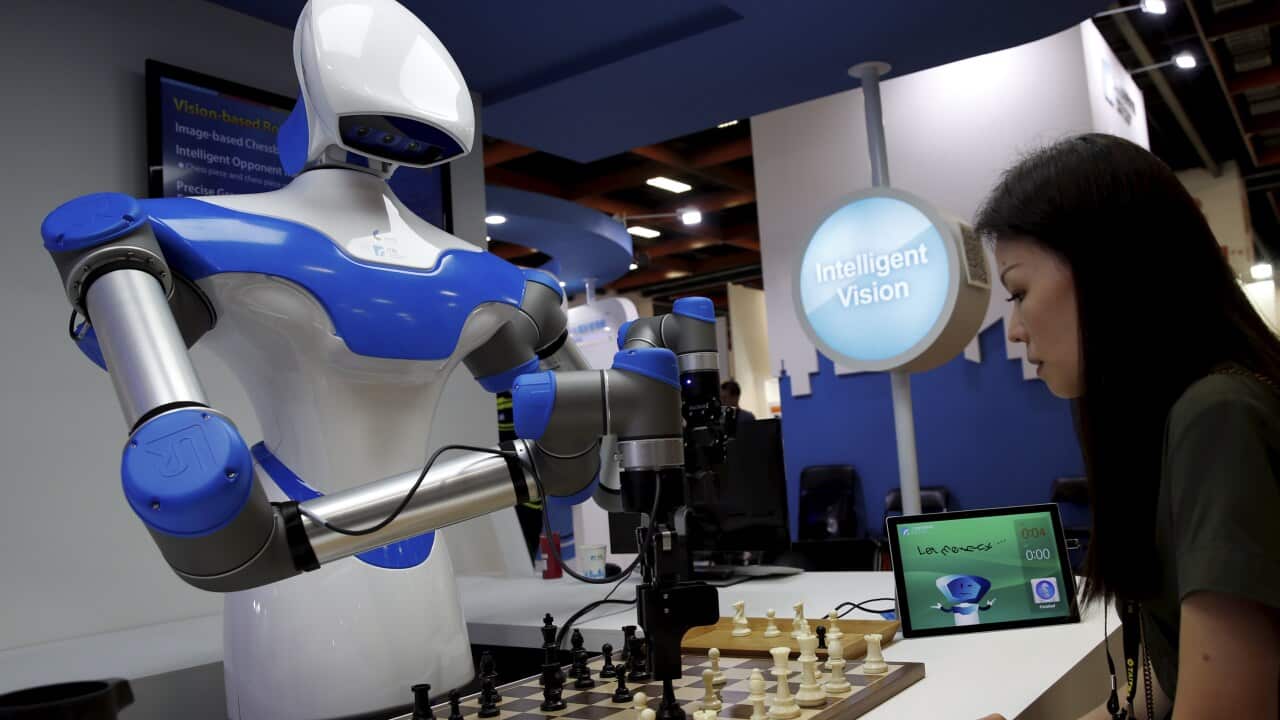 A visitor plays chess match against a robot during the COMPUTEX in Taipei, Taiwan, 30 May 2017