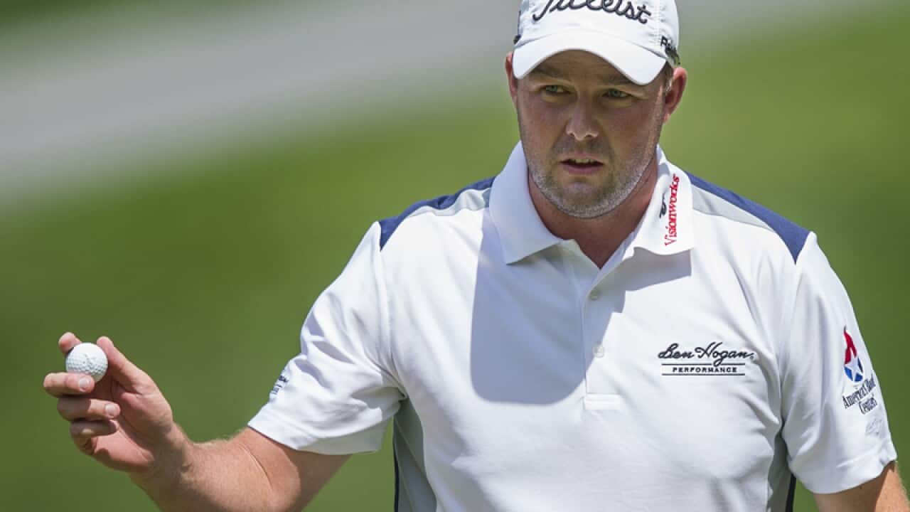 Australian golfer Marc Leishman gestures with his ball