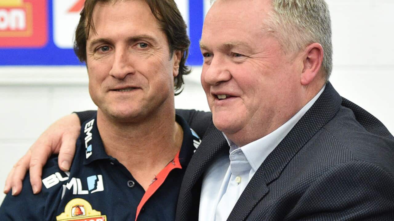 Luke Beveridge (left) embraces Peter Gordon