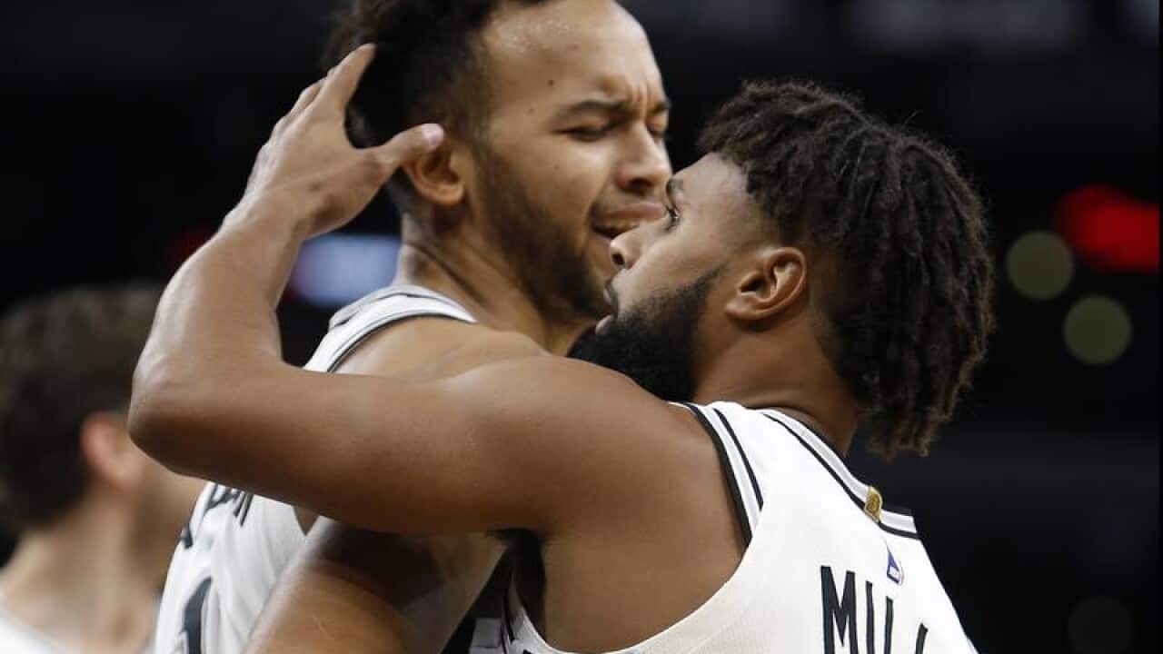 Patty Mills(8) celebrates with teammate. Kyle Anderson