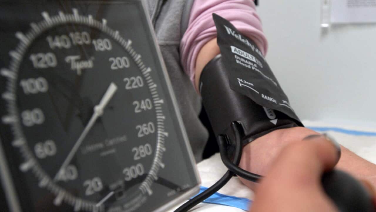 A patient has her blood pressure checked in Canberra