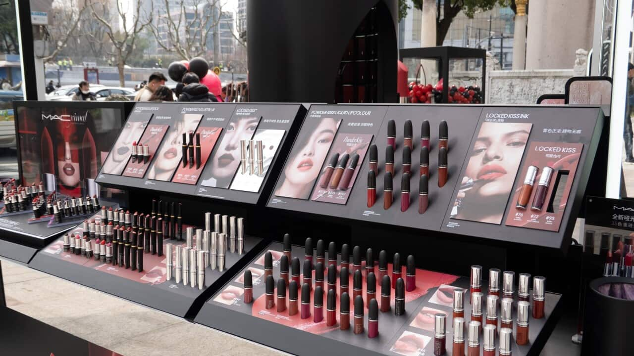 A makeup counter displaying lipstick varieties for sale in a shop.