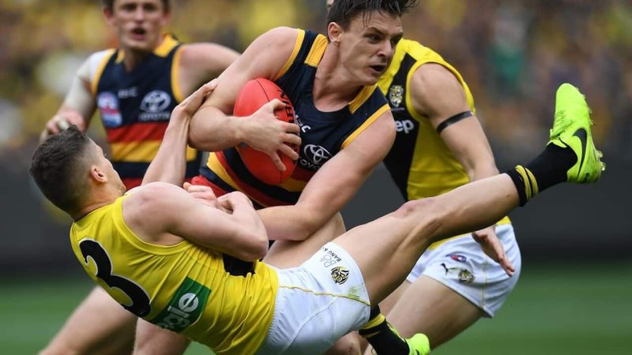 Jake Lever of the Crows and Dion Prestia of the Tigers contest.
