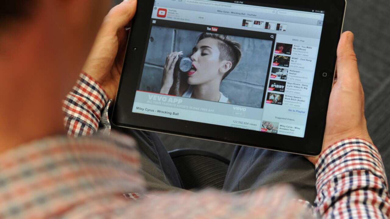 A man watcher a music video on an iPad