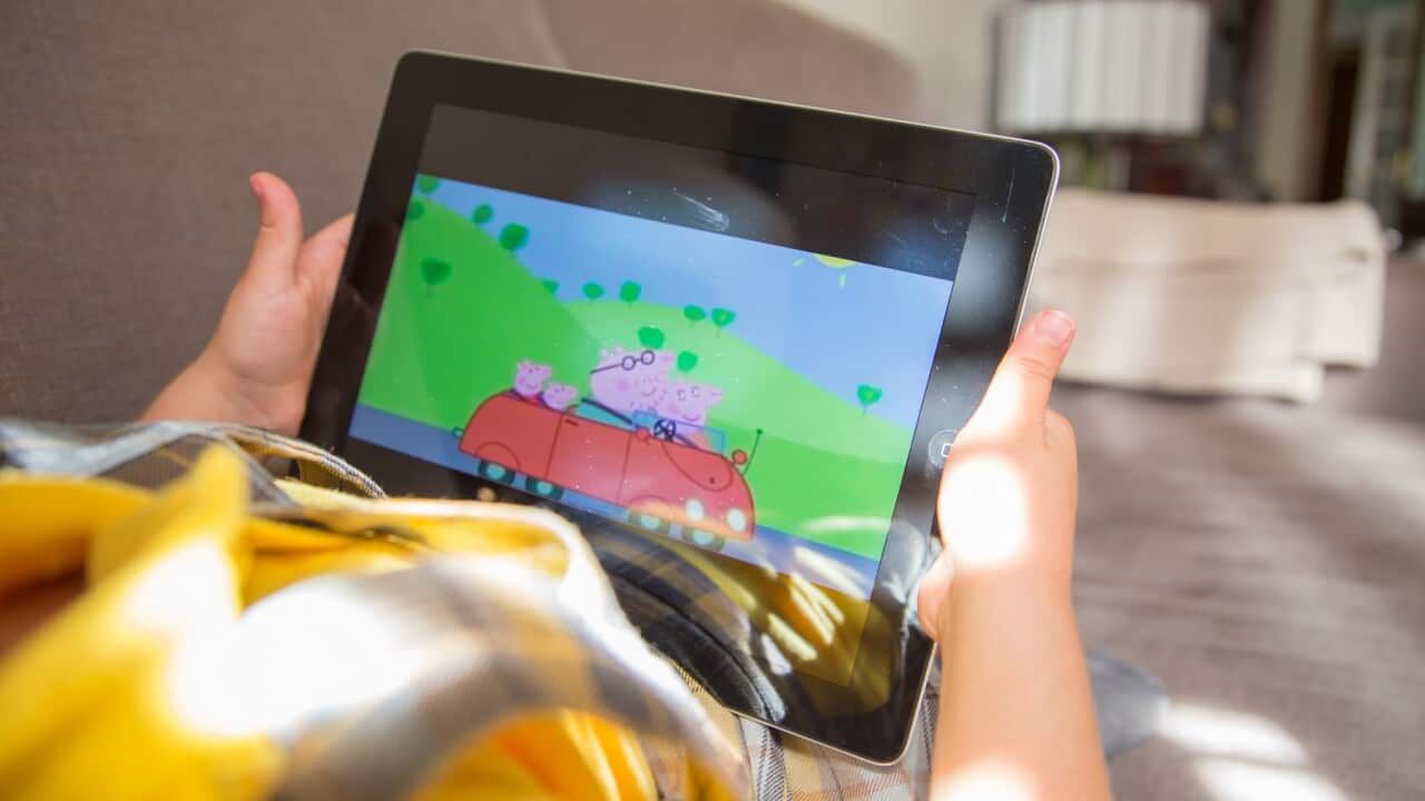 A child watching a 'Peppa Pig' cartoon on a tablet