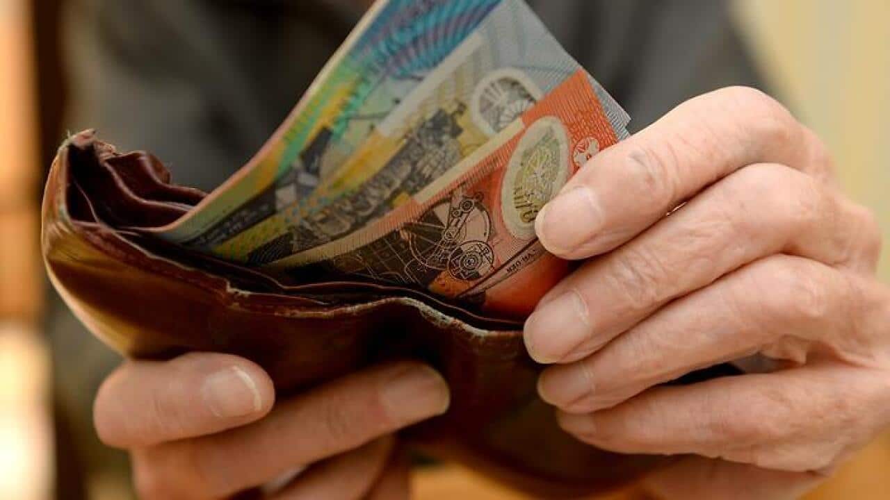 Money is taken out of a wallet Canberra, April 8, 2014. Aged pensions are expected to be hit in the upcoming 2014 budget. (AAP Image/Alan Porritt) NO ARCHIVING