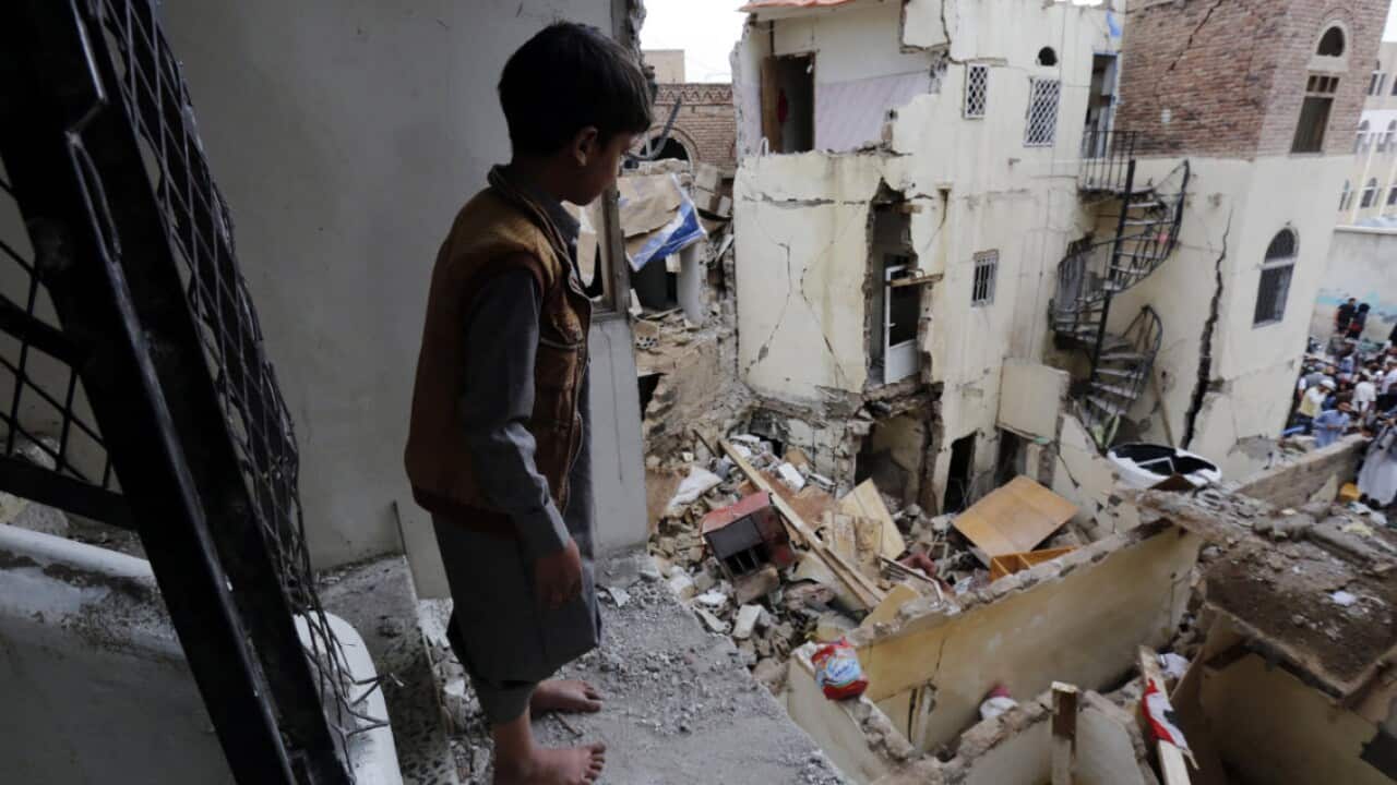 File image of a boy looking at destroyed houses at a neighborhood, a day after being targeted by a Saudi-led airstrike, in Sanaa.