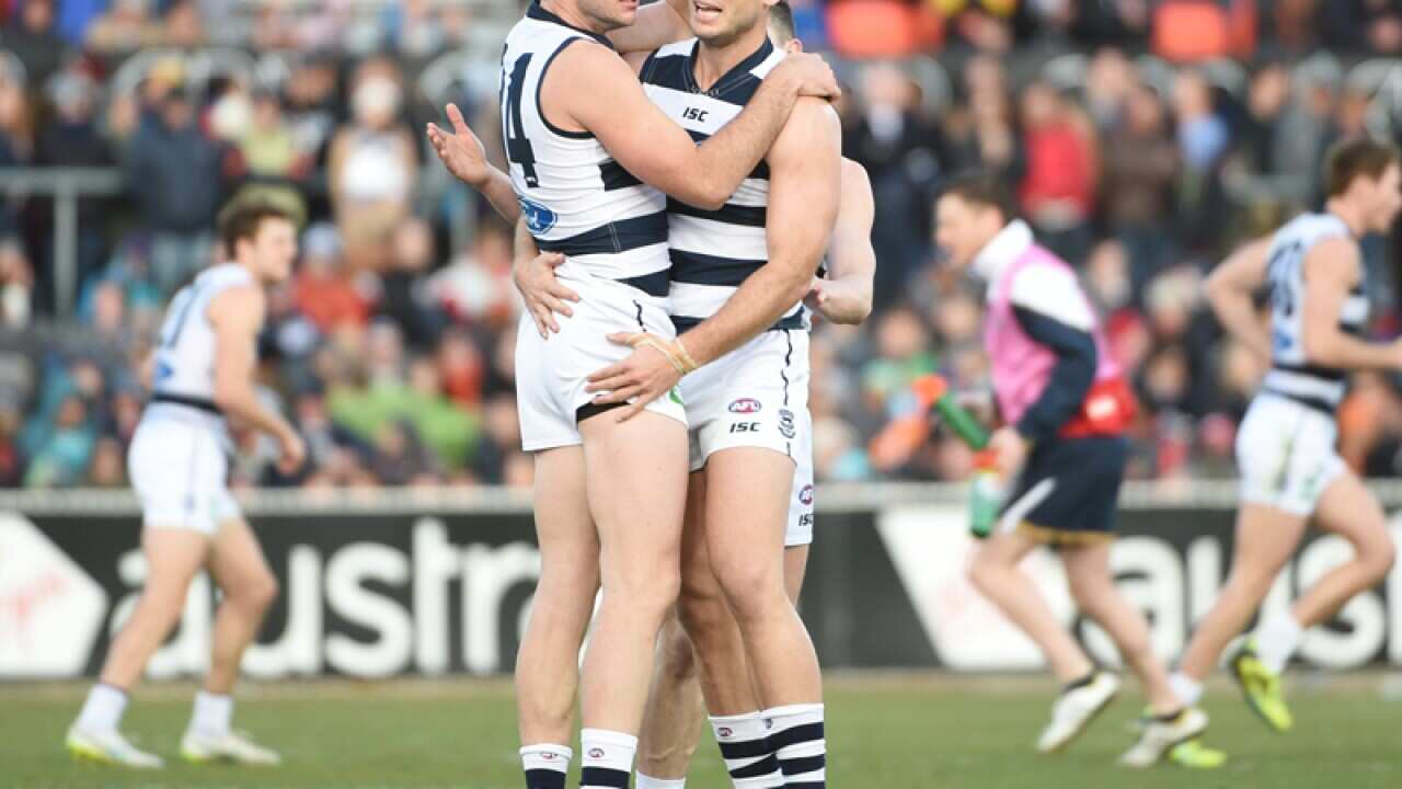 Cats players Josh Walker (L) and Tom Hawkins