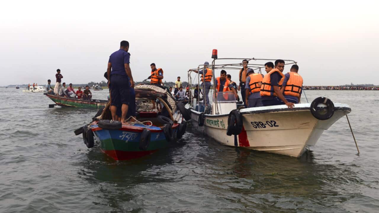 Bangladeshi rescuers look for bodies in the River Meghna