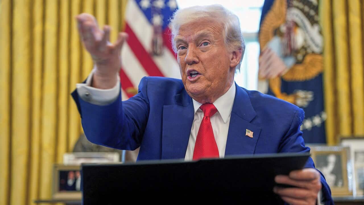 Donald Trump sitting in the Oval Office.