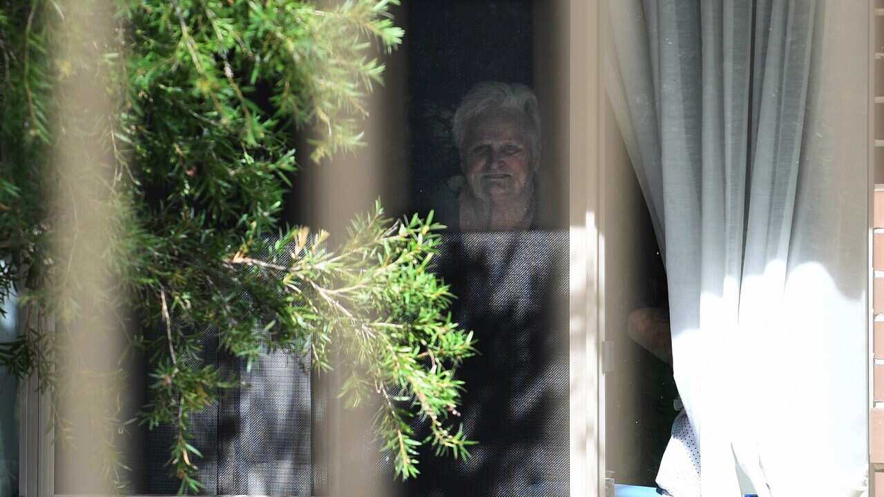 Patricia Shea looks out from her bedroom window at Anglicare's Newmarch House aged care home