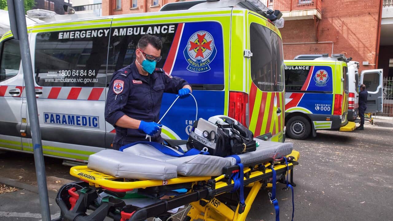 A paramedic moves equipment outside St. Vincent's Hospital in Melbourne as a Code Brown is declared