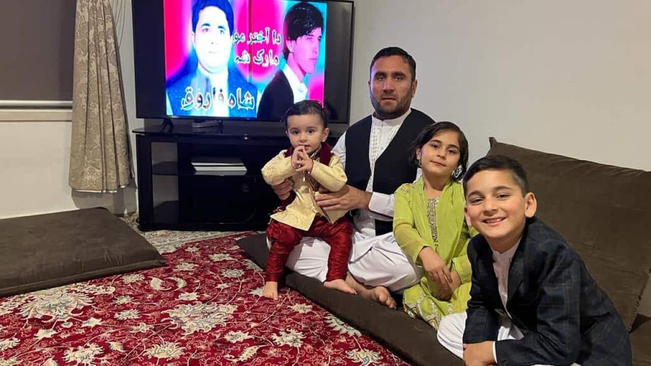 Sayed Wahdat Saddat and his children are pictured wearing traditional Afghan clothes for Eid in Melbourne.