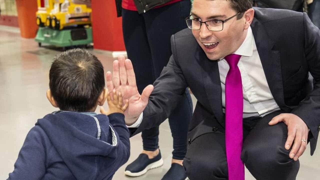 Labor candidate for Perth Patrick Gorman hi-fives a child in Perth