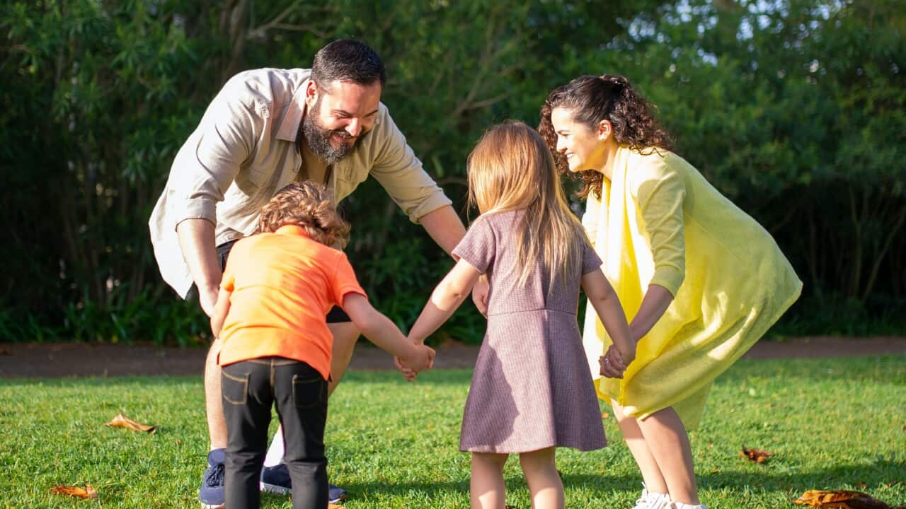 A foster family playing in the park