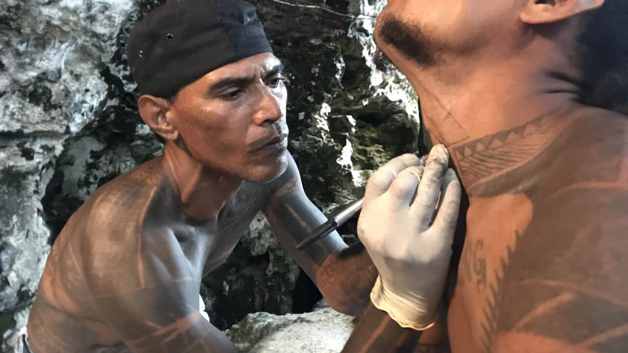 Boland Greene prepares to ink a throat tattoo on Bellona
