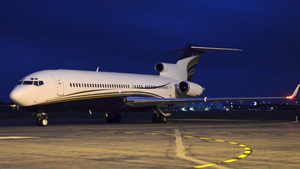 A plane arrives carrying the South African president.