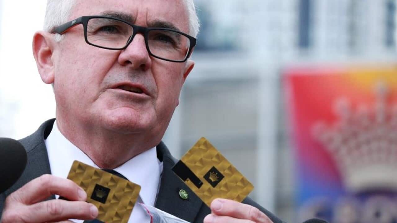 Independent MP Andrew Wilkie displays Crown Casino VIP member cards.