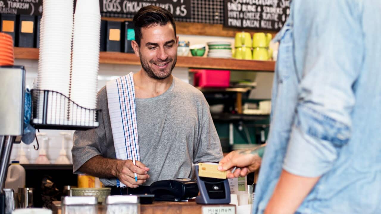 settlement guide, a customer is paying a bill in a caffe