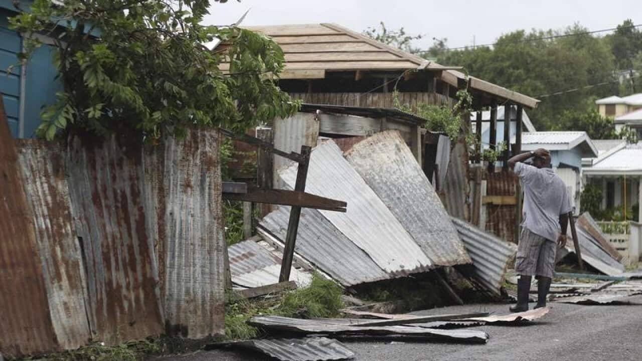 A man surveys wreckage at his property in Antigue and Barbuda