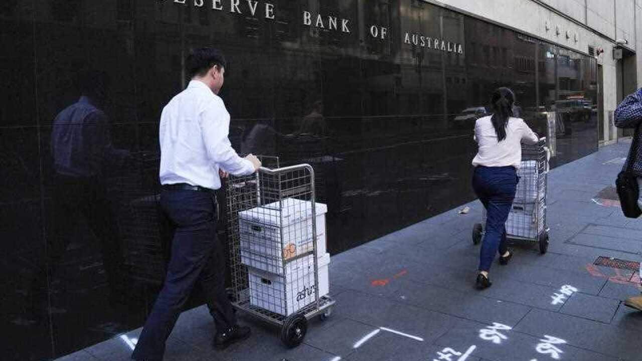 People walking past RBA in Sydney