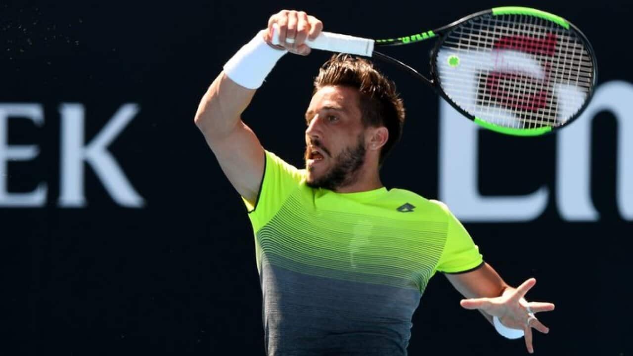 Damir Dzumhur of Bosnia-Herzegovina in action against John Millman of Australia during round two on day three of the Australian Open tennis tournament in Melbourne, Wednesday, January 17, 2018. (AAP Image/Joe Castro) NO ARCHIVING, EDITORIAL USE ONLY