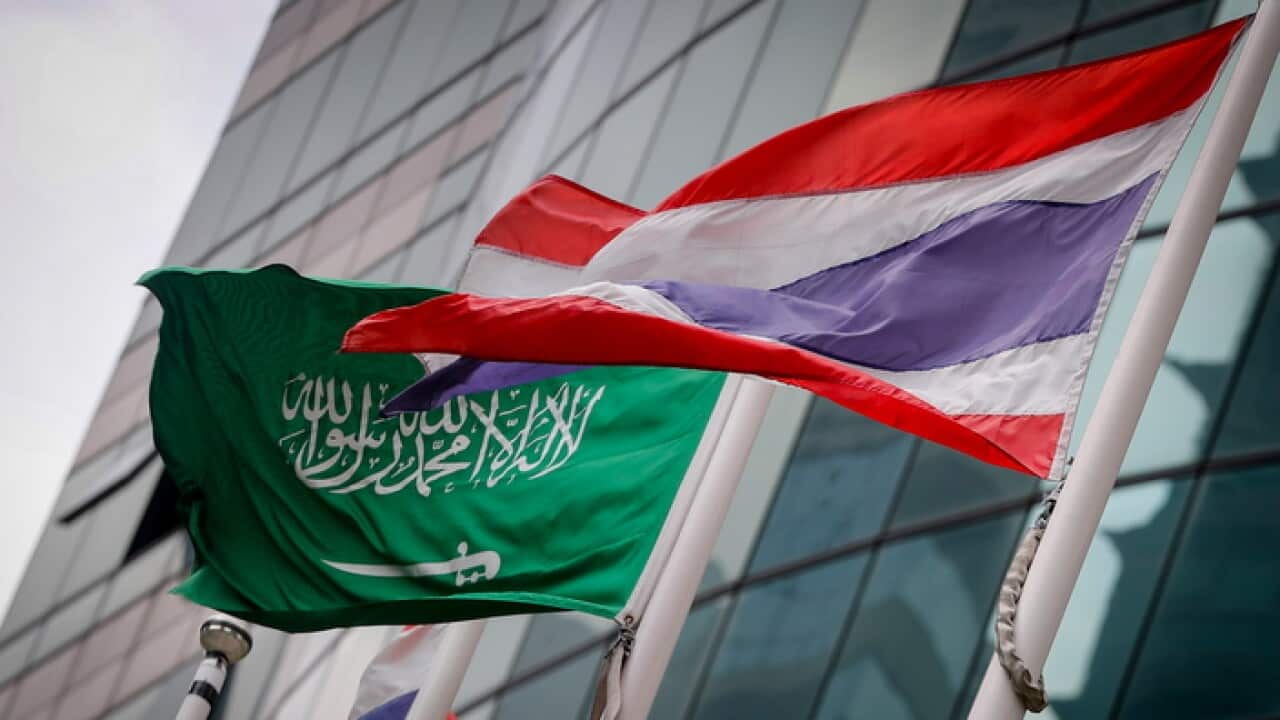 A Saudi Arabian national flag flies next to a Thai national flag outside the Saudi embassy