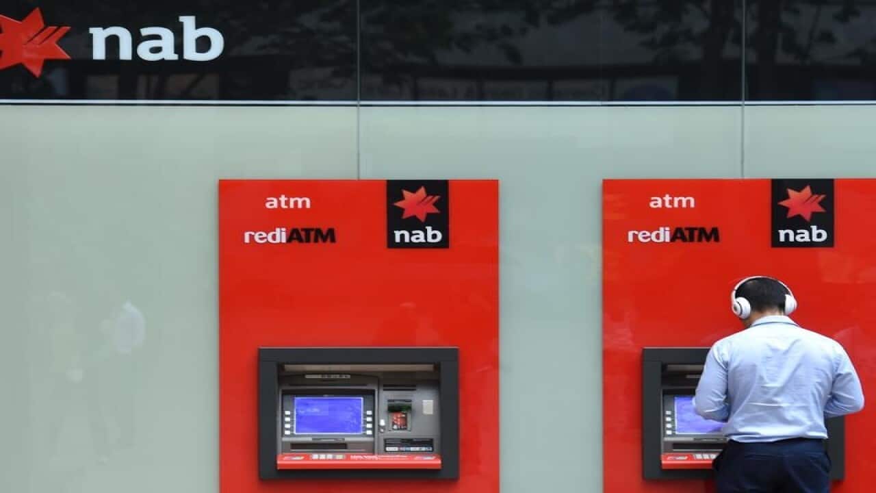 A man uses a National Australia Bank (NAB) ATM