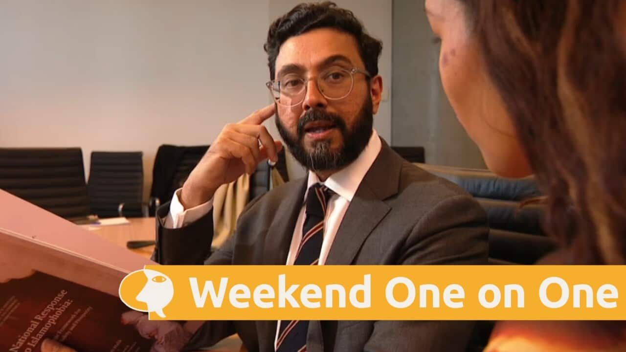 Islamophobia envoy Aftab Malik looks at through his report as he is interviewed.