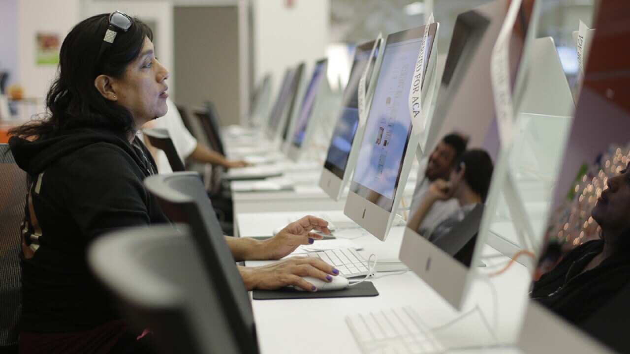 A woman uses a computer at a public library