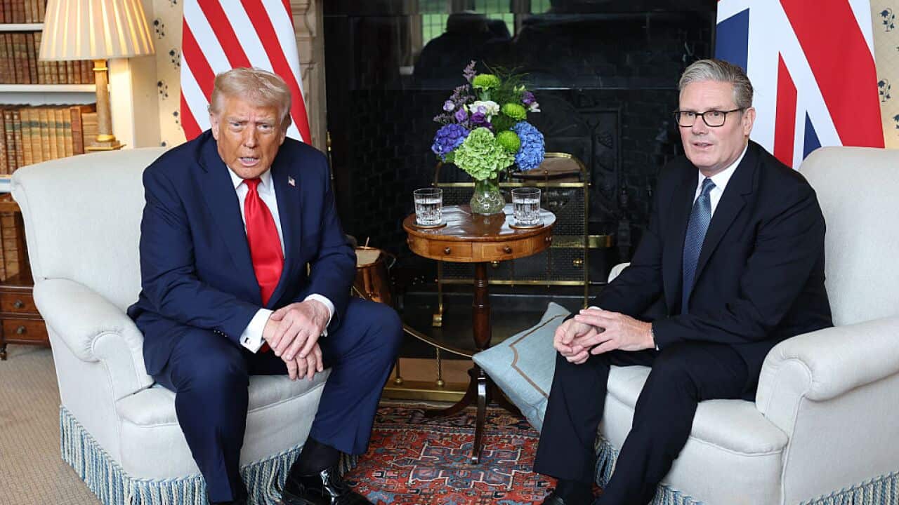 Donald Trump is seated beside Keir Starmer.