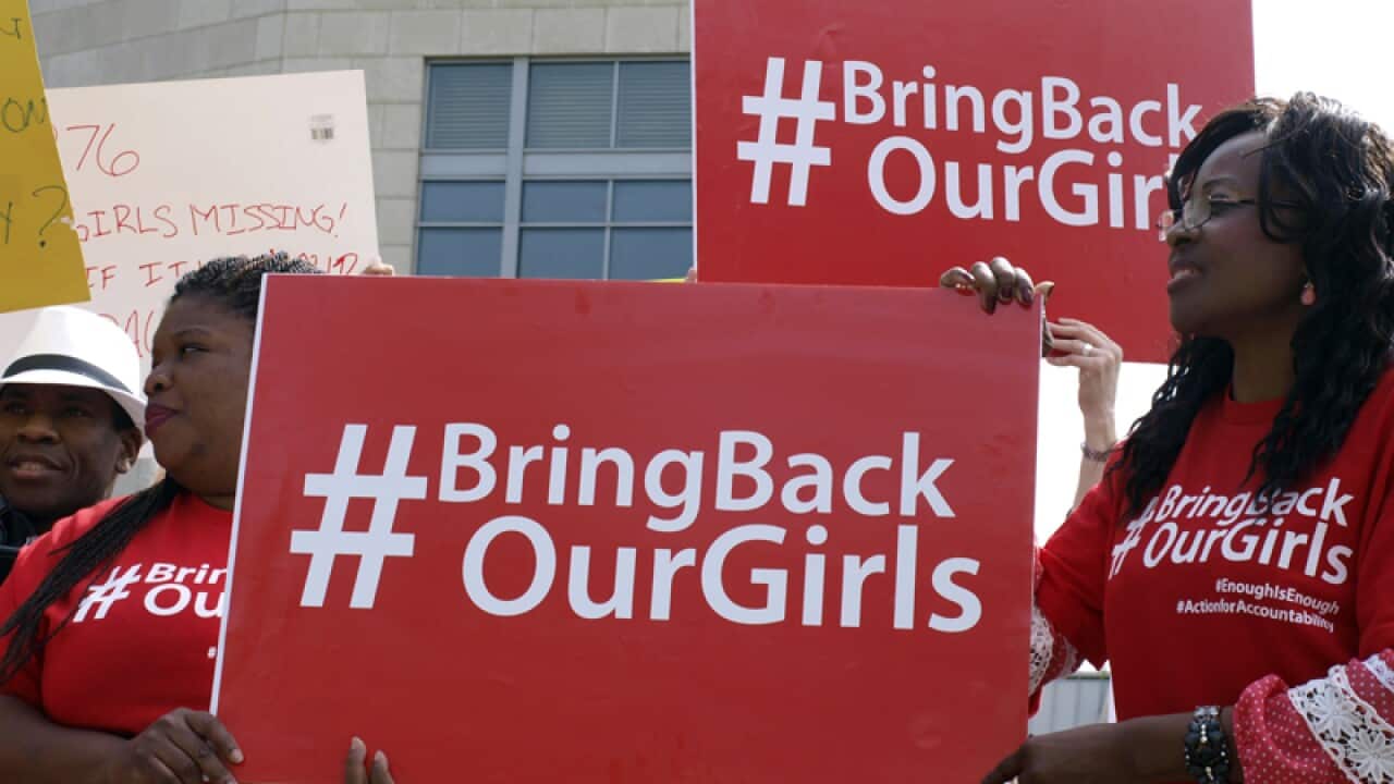 Protesters hold signs during a demonstration in Washington DC