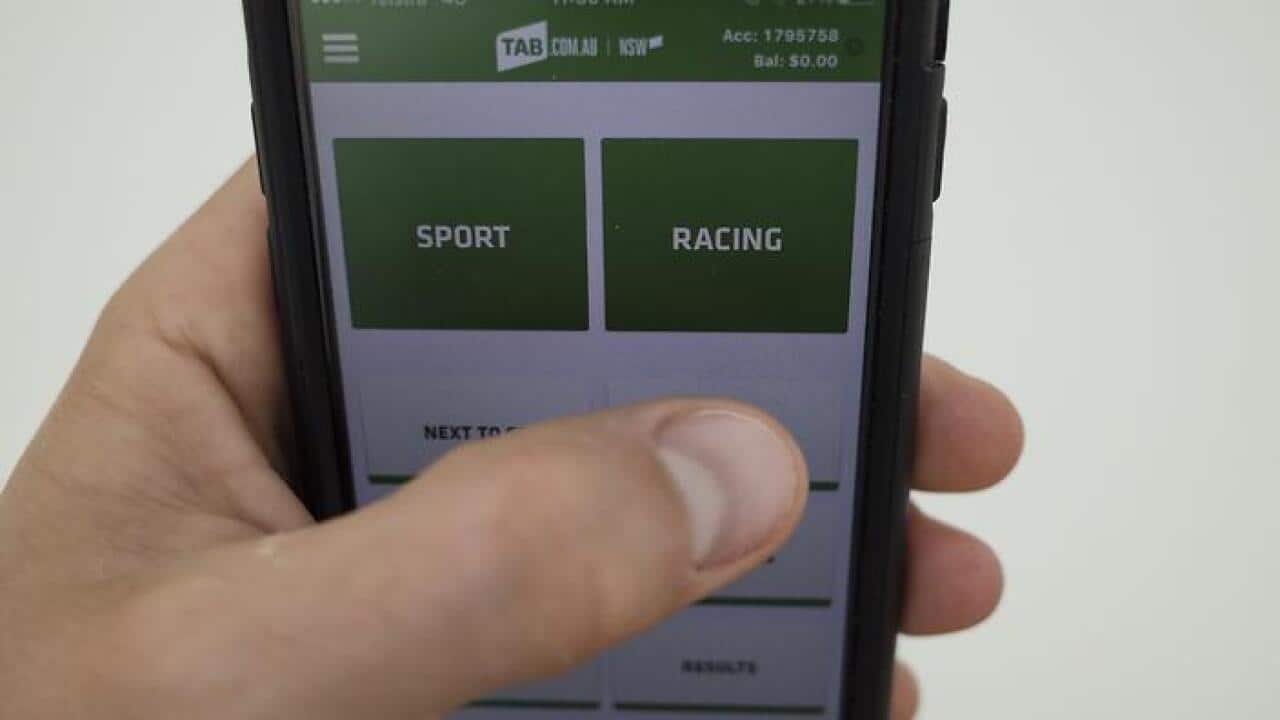 The TAB online betting app is seen on an iPhone in Canberra, Monday, Nov. 2, 2015. (AAP Image/Lukas Coch) NO ARCHIVING