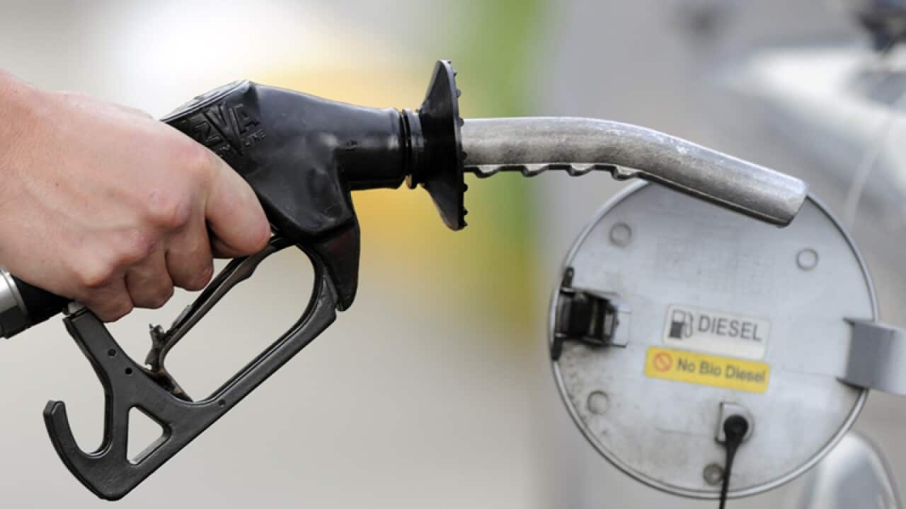 A man pumps petrol at a service station in Melbourne