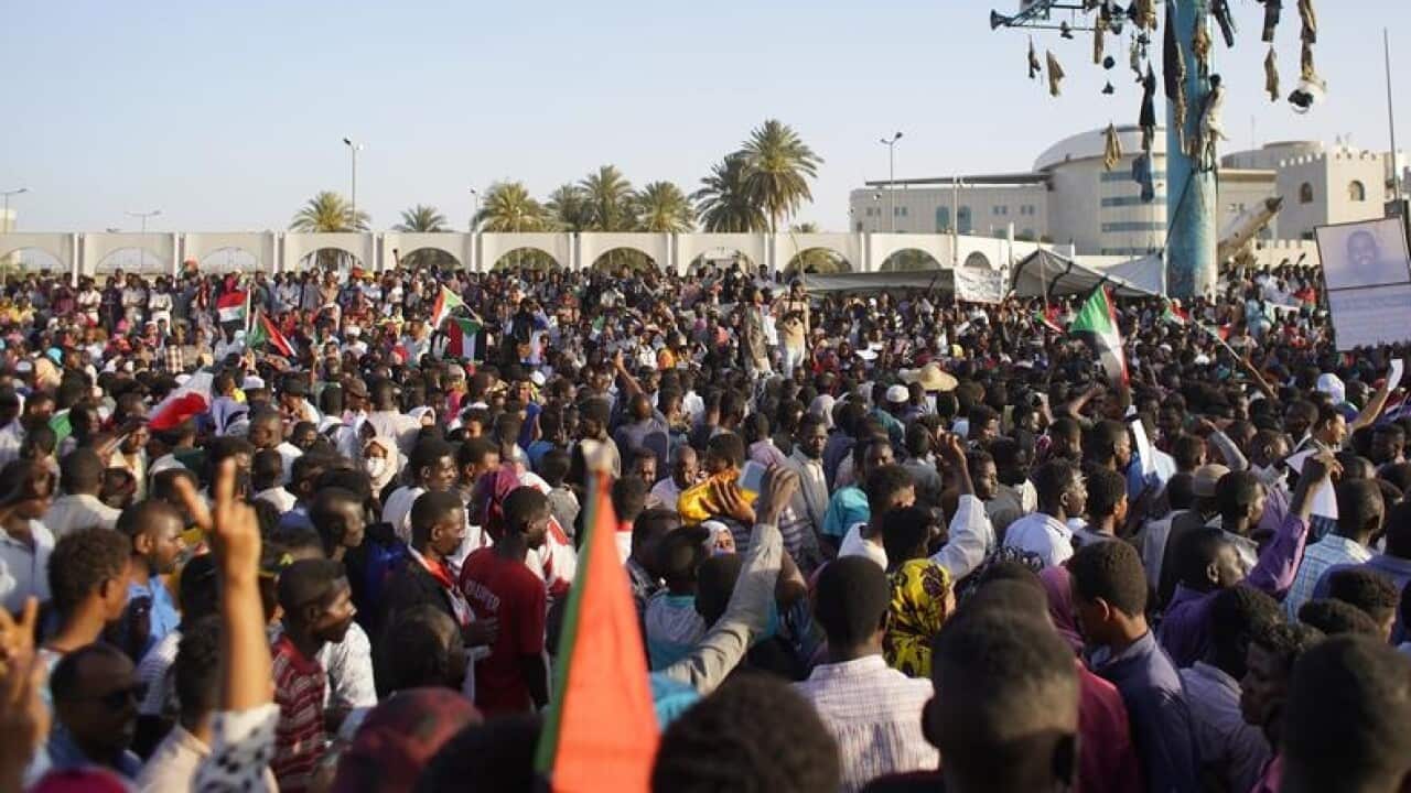 People chant slogans outside the military headquarters in Sudan