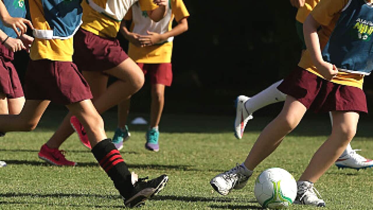 A young girl playing soccer.