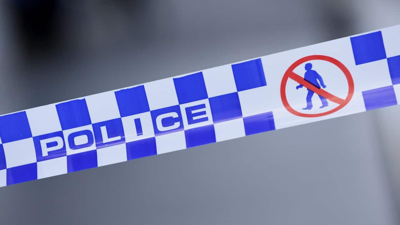 A stock photo showing a police tape placed around crime scenes
