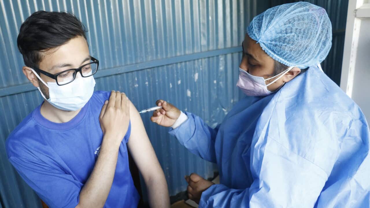 Nepali health workers receiving COVID-19 vaccine at a Kathmandu hospital.