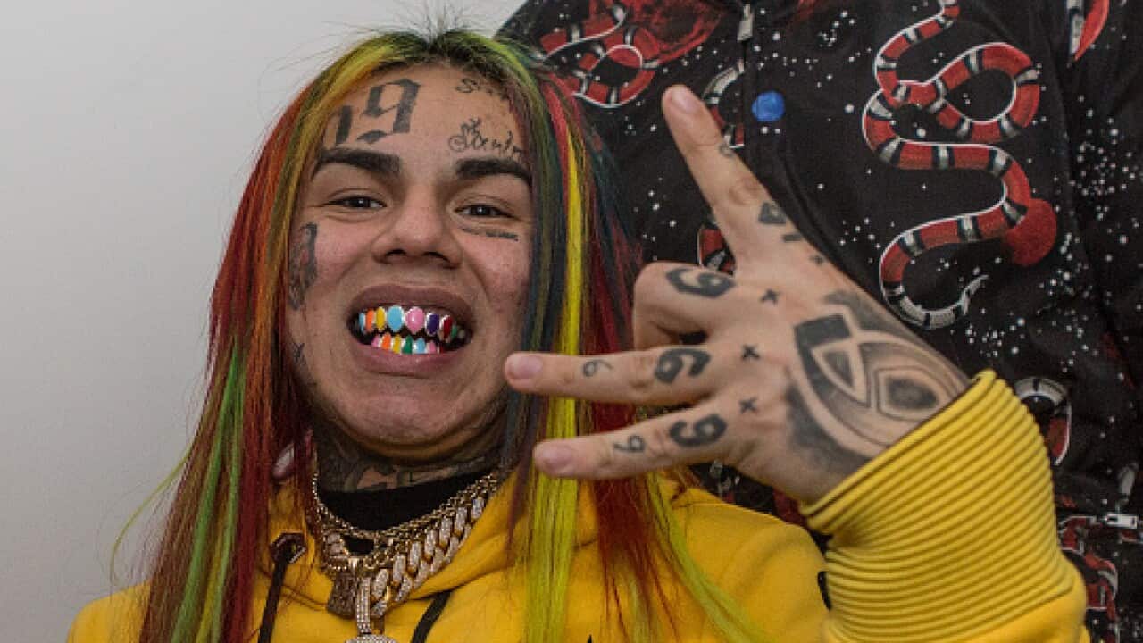 Rapper 6ix9ine claims he was beaten and robbed.
