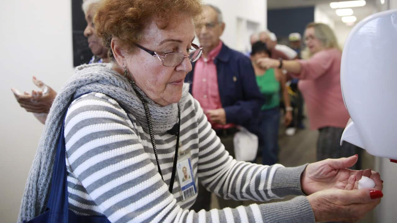 A woman uses hand sanitizer before eating lunch, as coronavirus poses a challenge for nursing homes and the elderly.