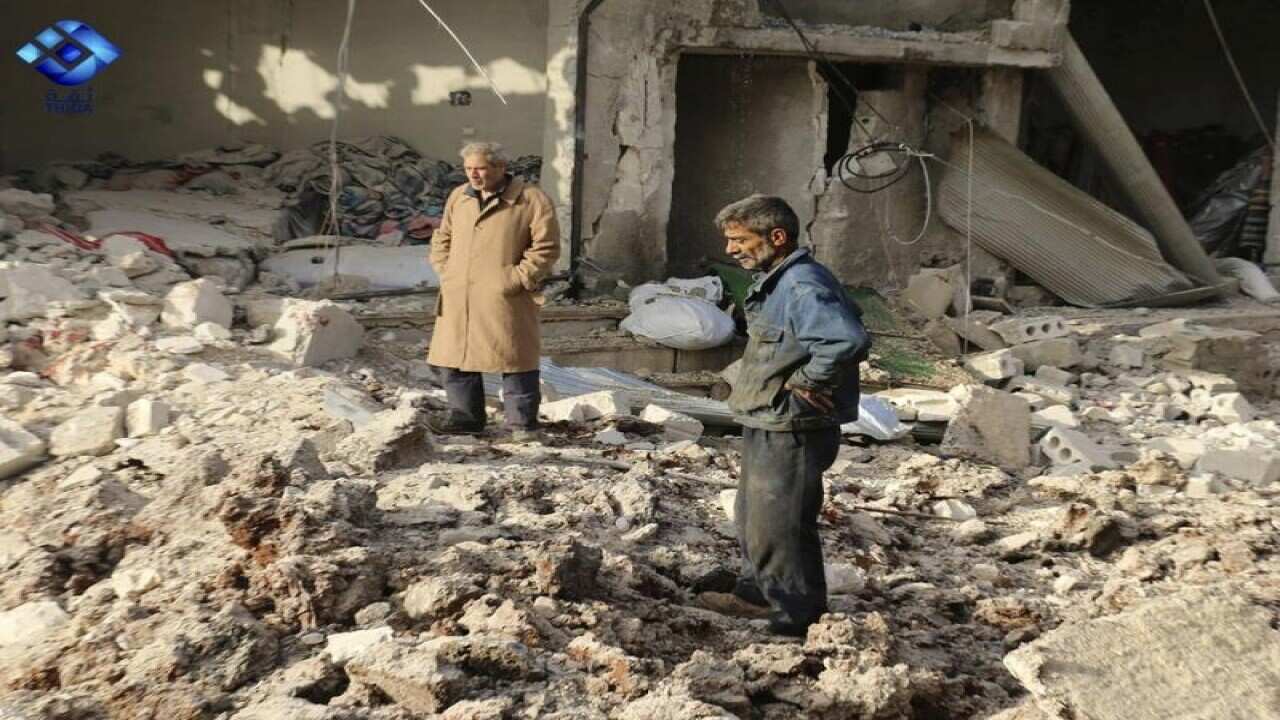Locals inspect the damage after an air strike