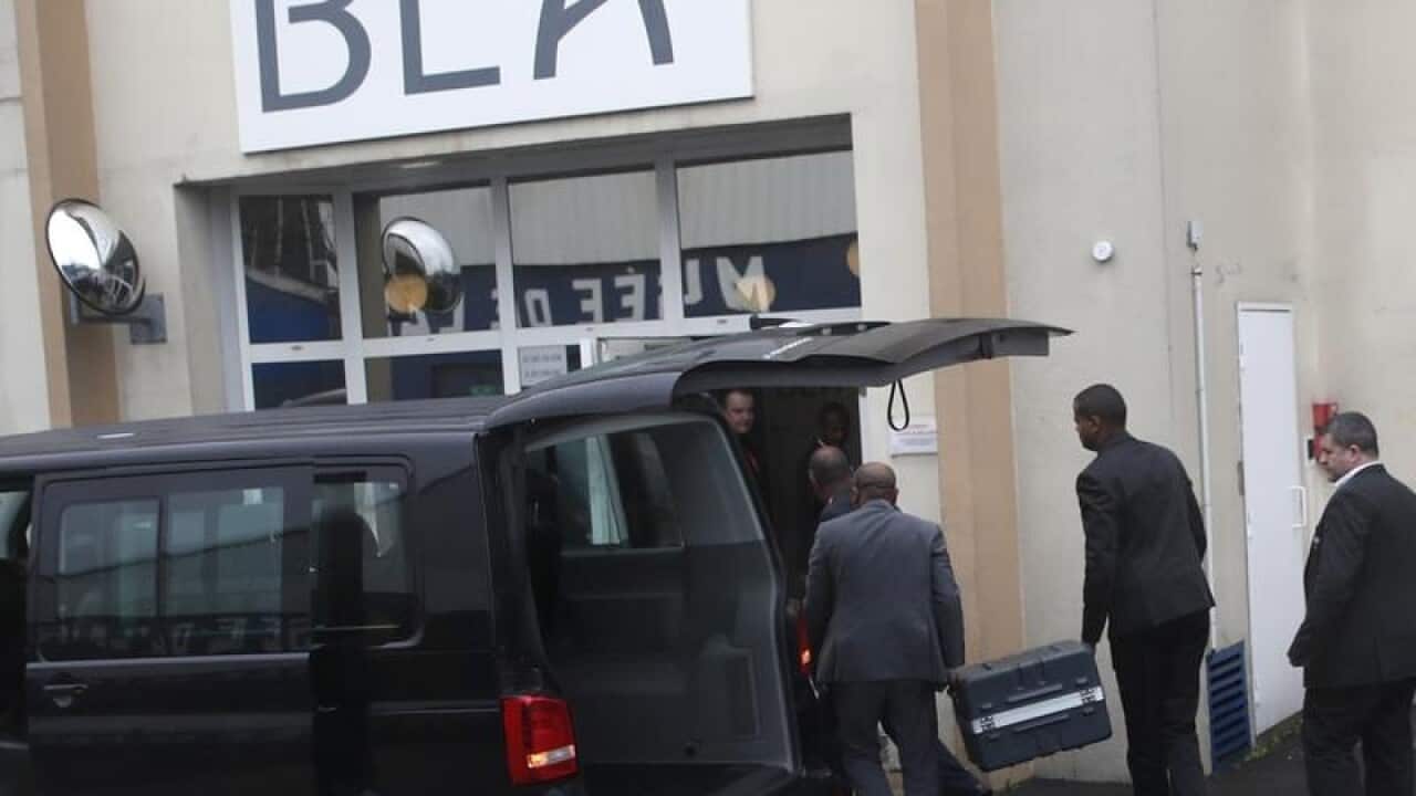 Cases containing the flight recorders are carried into the BEA office