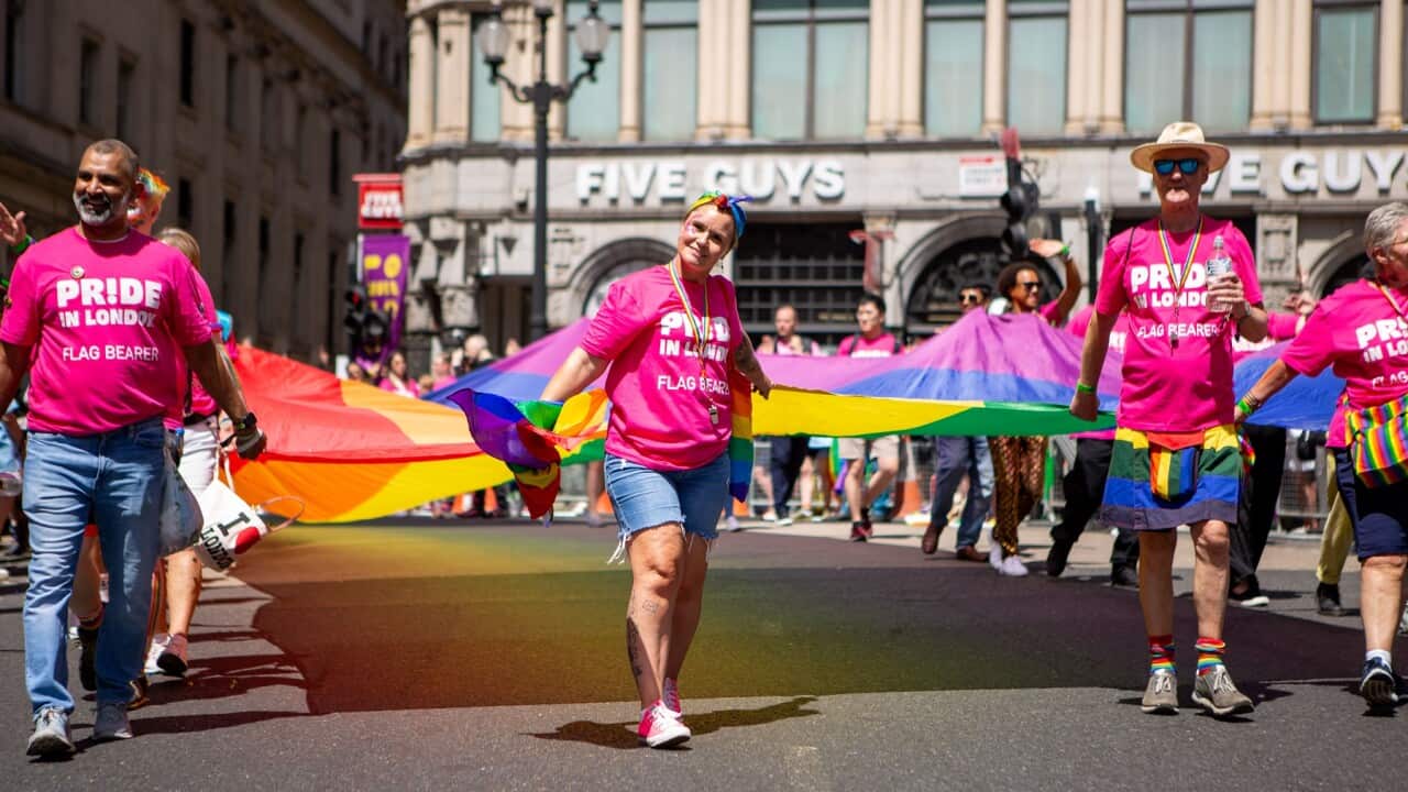Flag bearers carry a giant Pride flag during the parade in London.