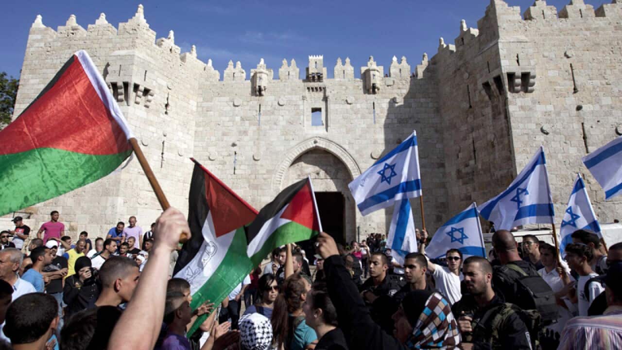 Israelis and Palestinians wave flags on Jerusalem Day