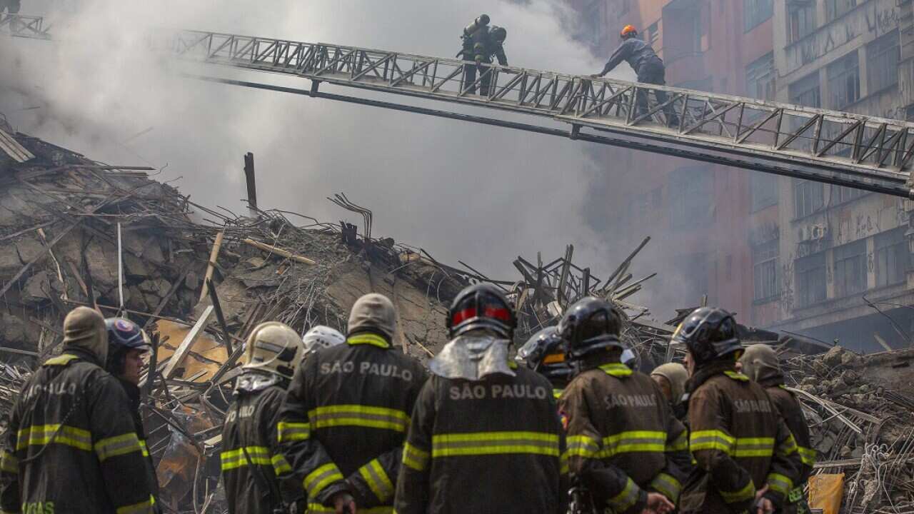 Firefighters at the scene after an overnight fire ravaged a 24-storey building used by squatters in the centre of Sao Paulo, Brazil.