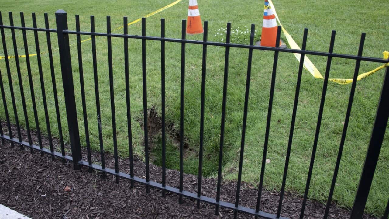 A sinkhole has opened the North Lawn of the White House across the driveway from the briefing room in Washington, DC, USA on Tuesday, May 22, 2018. 