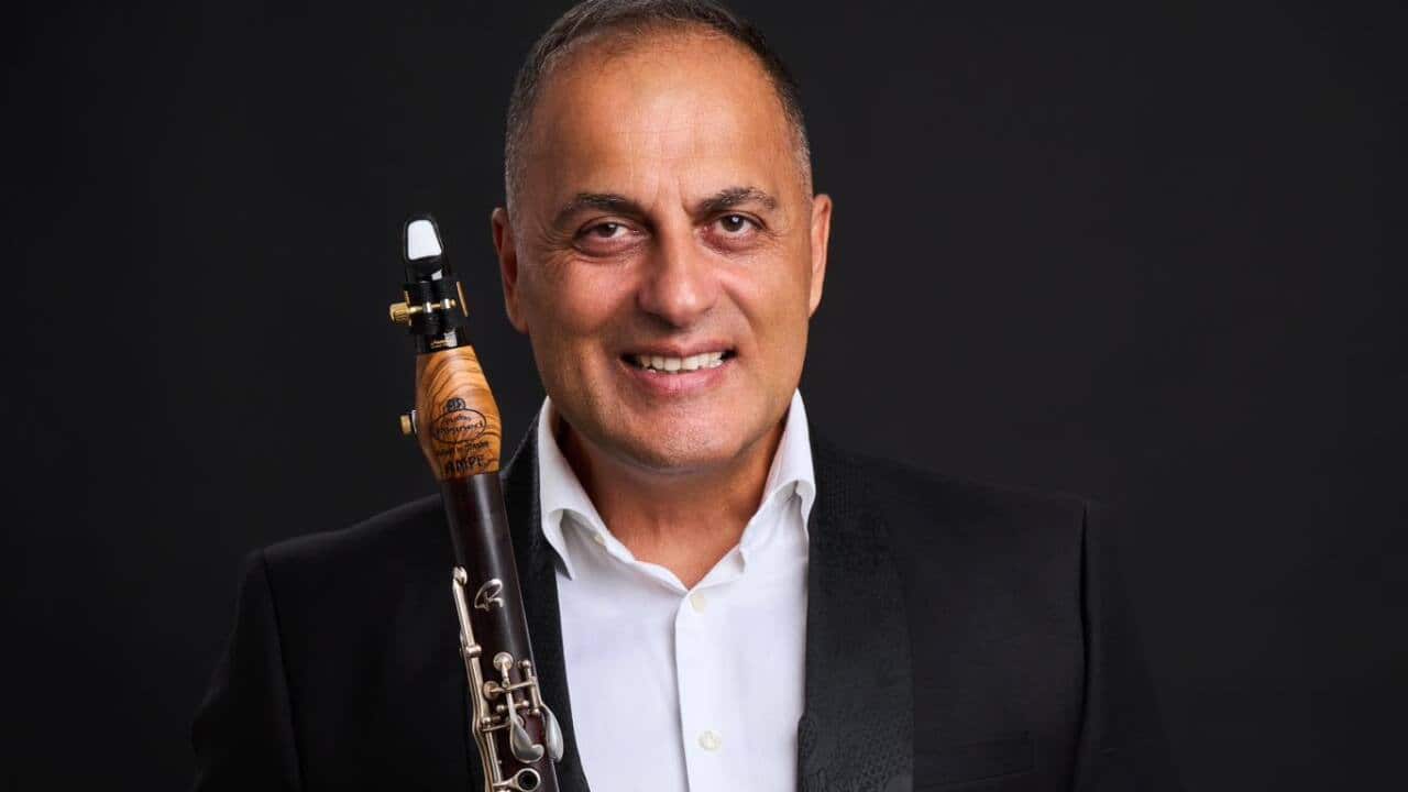 ILIJA AMPEVSKI- PHOTO FB- standing holding clar w black suit white shirt.jpg